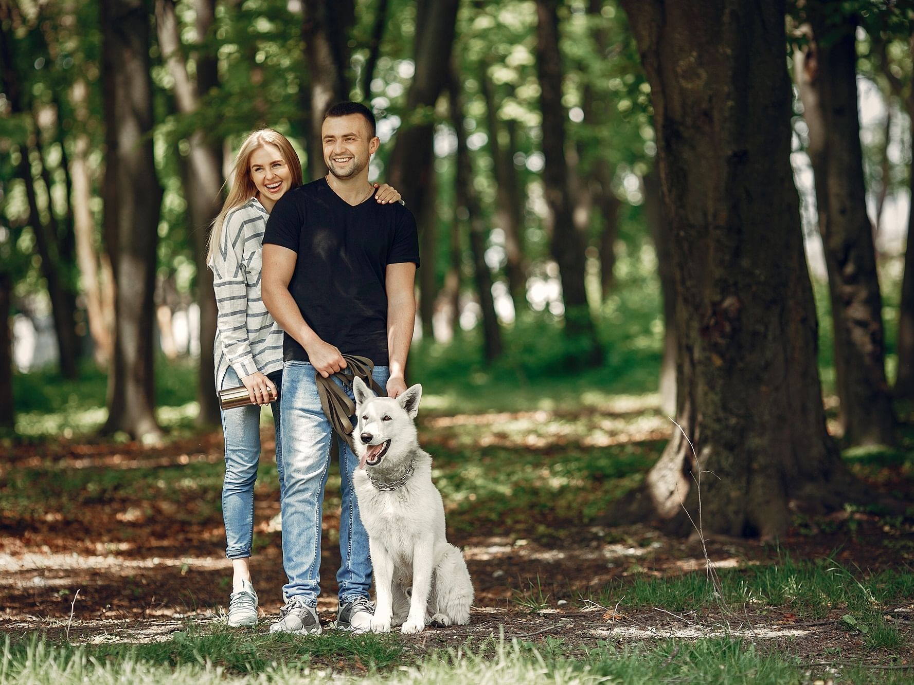 A couple with a dog in the woods at Aachen near Rheinland Hotel Kollektion