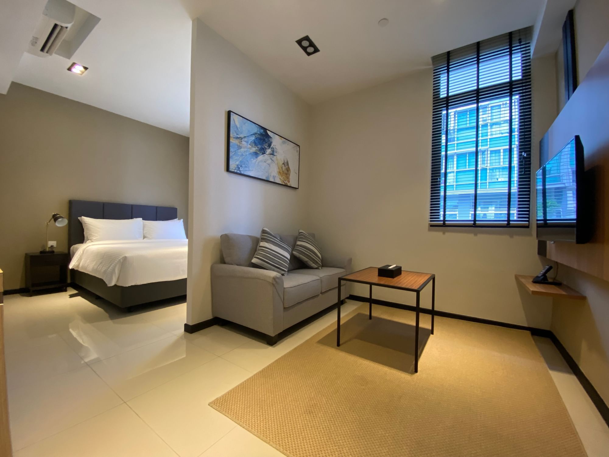 Living area with bedroom in Studio Apartment Momentus Novena