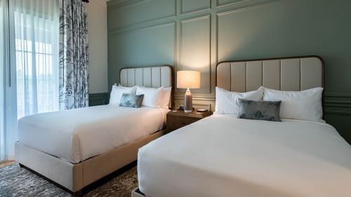 Lamp by the twin beds in Golf View Queen Room With Balcony at Camp Creek Inn