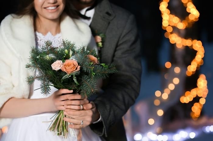 Couple dressed ready for their winter wedding at Gorse Hill in Surrey