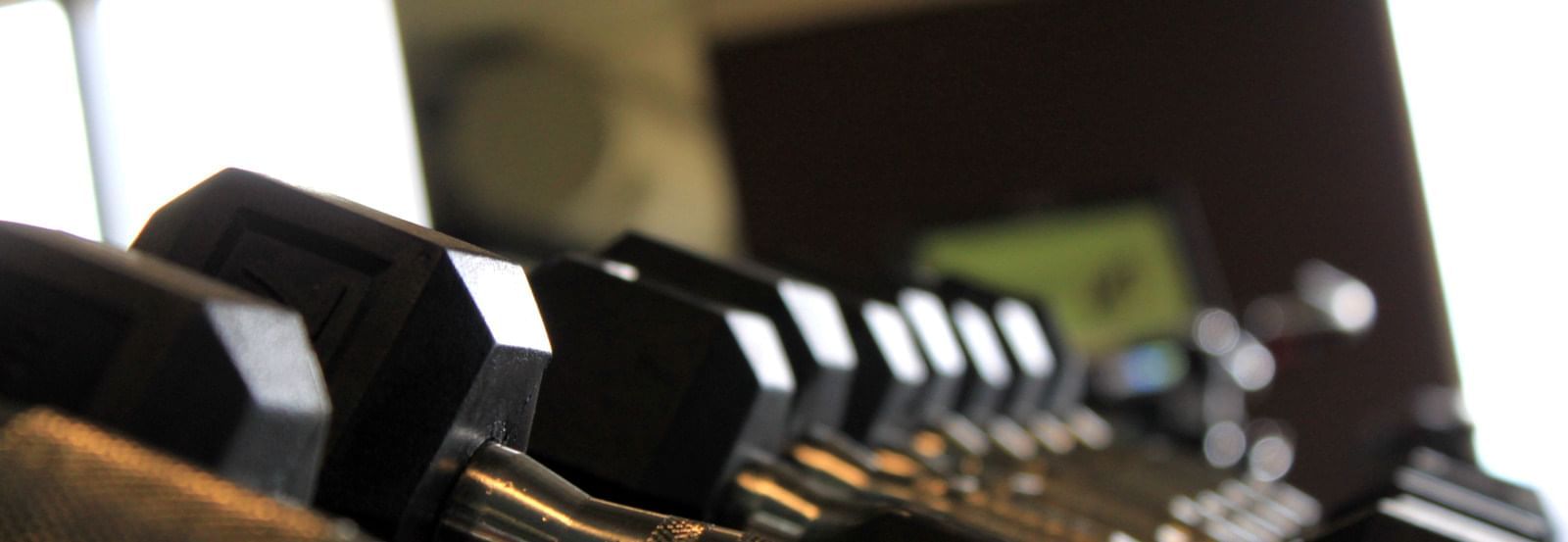 Close-up on a row of dumbbells in the gym at The Grove Hotel