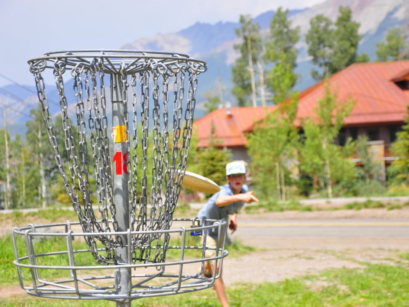 A child playing disc golf at Elegante Lodge & Resort Ruidoso