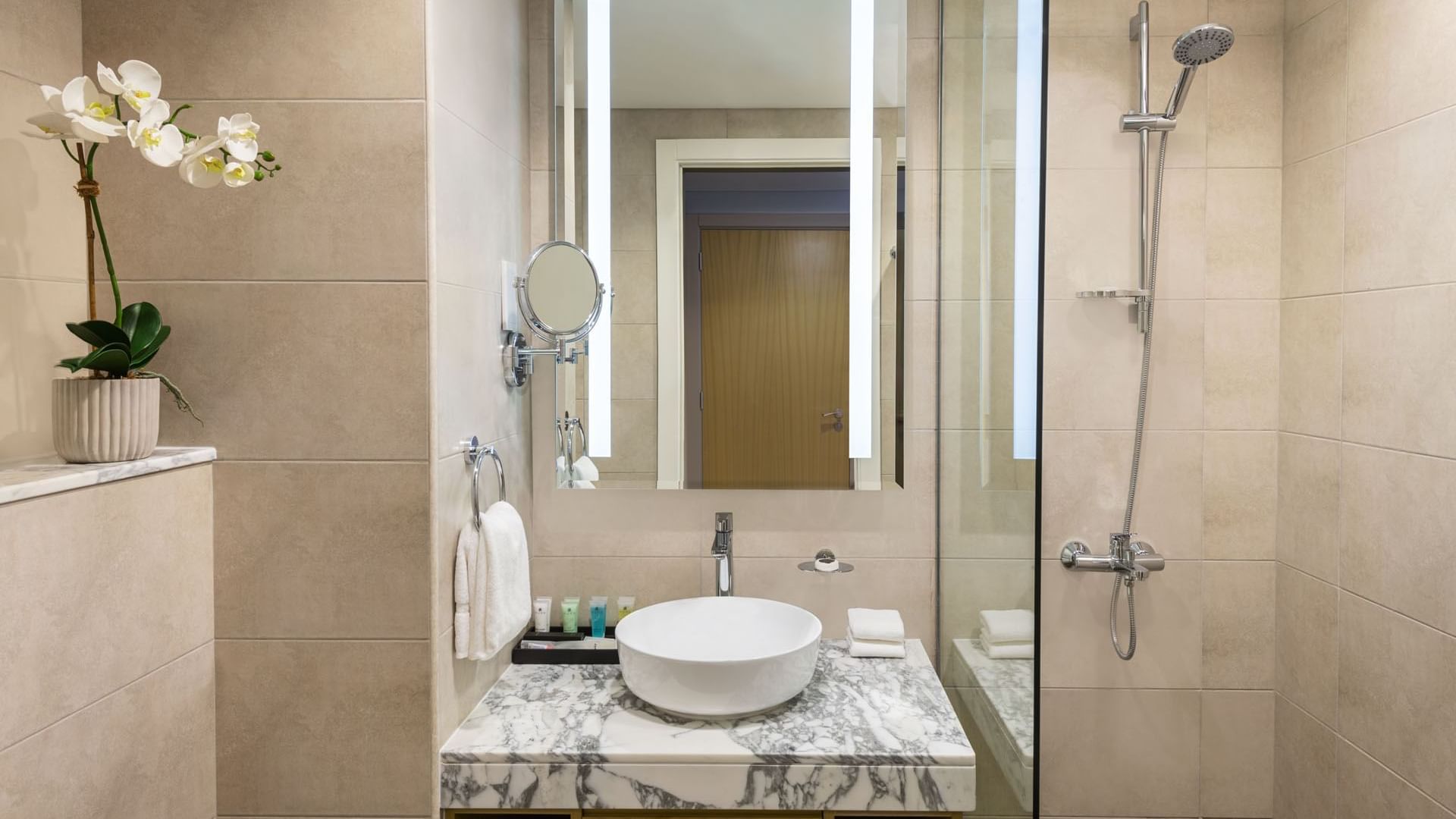 Bathroom shower by the marbled vanity in a Suite at DAMAC Maison Aykon City Hotel Apartments