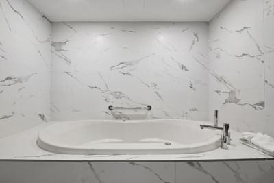 bathtub with marble walls