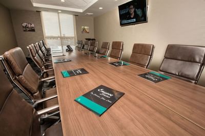 Boardroom table arrangement in a meeting room at Encore Suites Grande Prairie