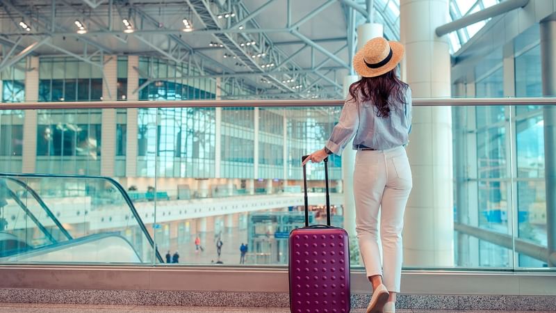 Woman in airport waiting on transfer near Luxury Suites Amsterdam