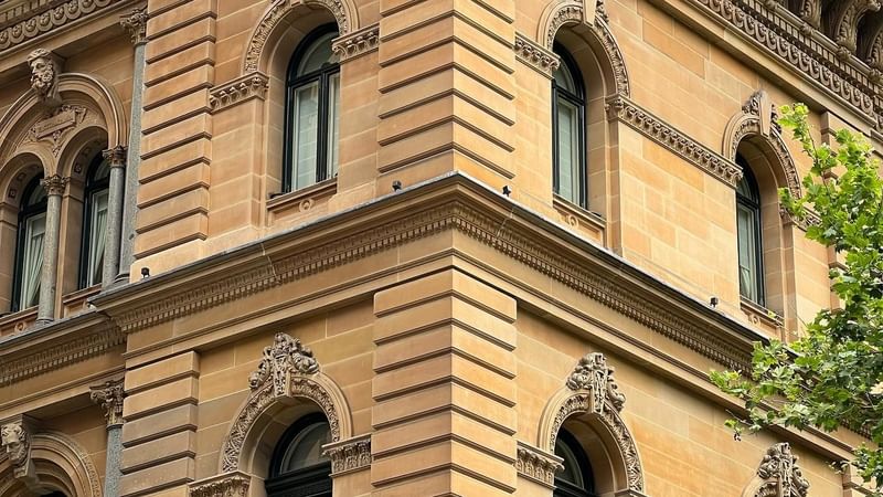 Architecturally building featuring intricate windows at Fullerton Hotel Sydney
