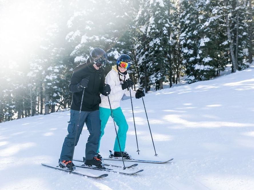 Couple skiing Deer Valley Resort near Stein Eriksen Residences
