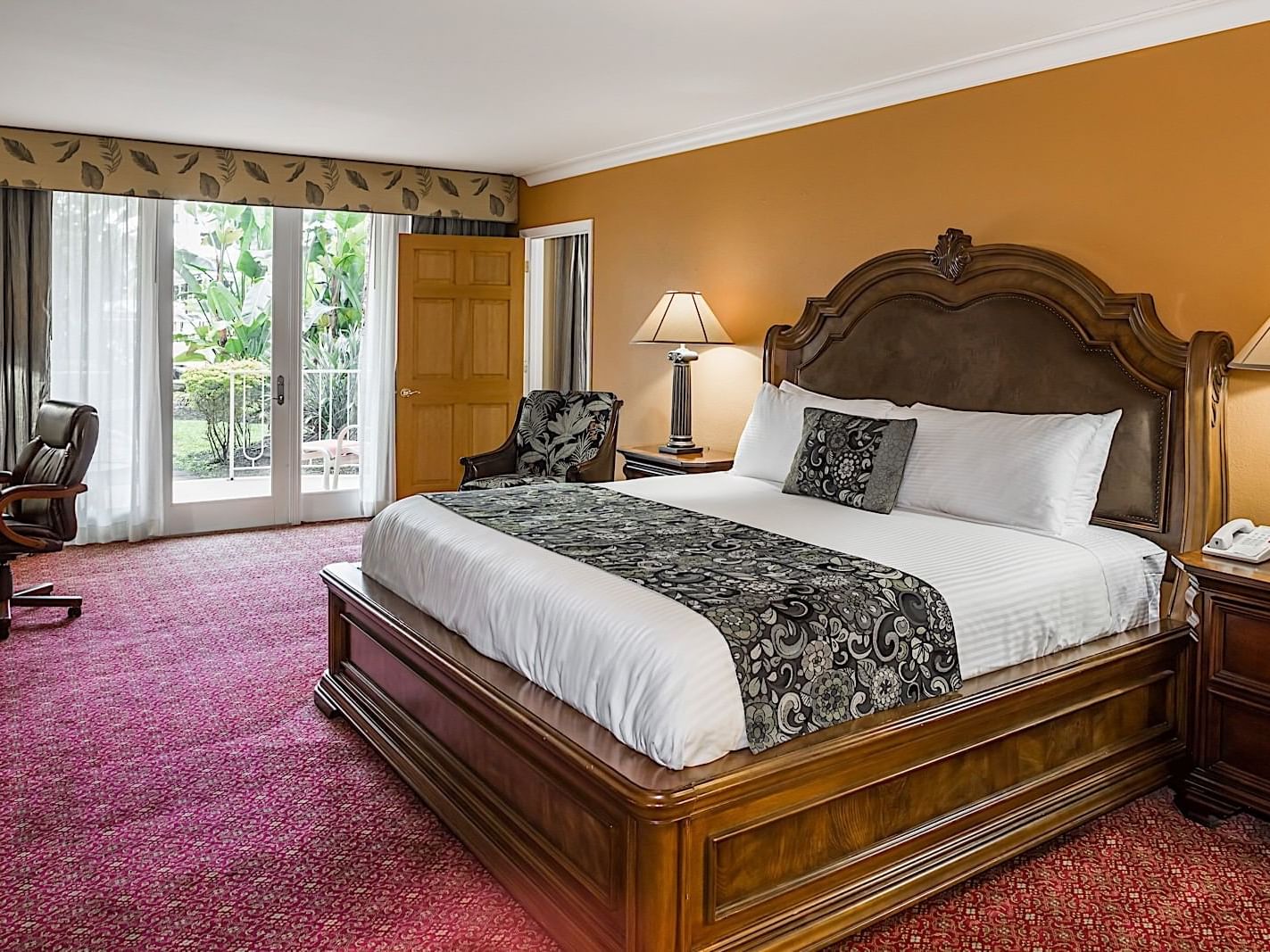 King Bedroom with a large bed with access to the pool at the Safety Harbor Resort and Spa.