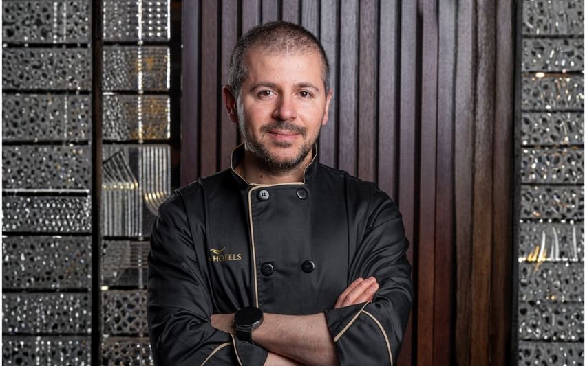 Portrait of a Răzvan Roşu wearing a black uniform with gold embroidery, standing at Ana Hotels