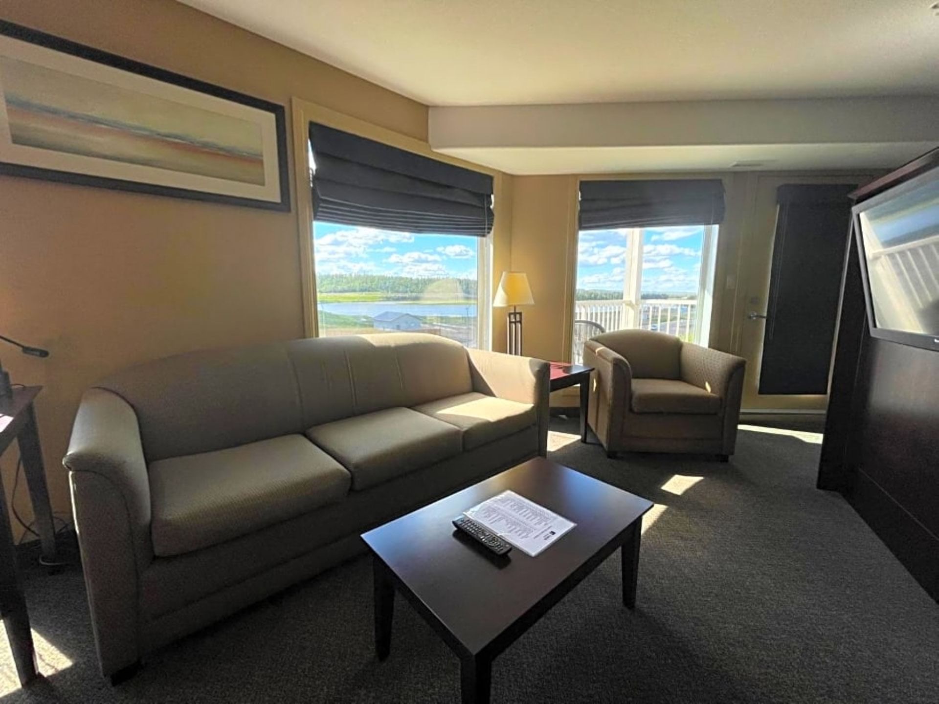 Livingroom area overlooking the lake in Studio One Queen Bed at Franklin Suite Hotel, Downtown Fort Mcmurray