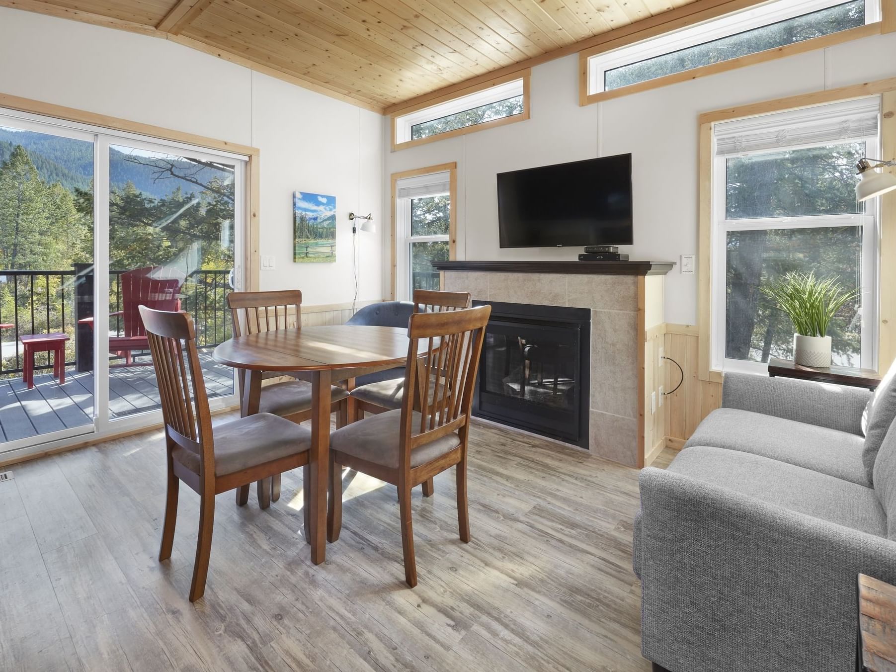 Mountain View Cabin with dining table, sofa and a TV at Fairmont Hot Springs Resort