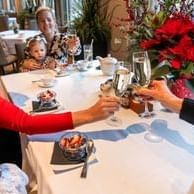 Adults toasting with champagne and enjoying Mother's Day Brunch Buffet at Spring Creek Resorts, featuring Canmore events