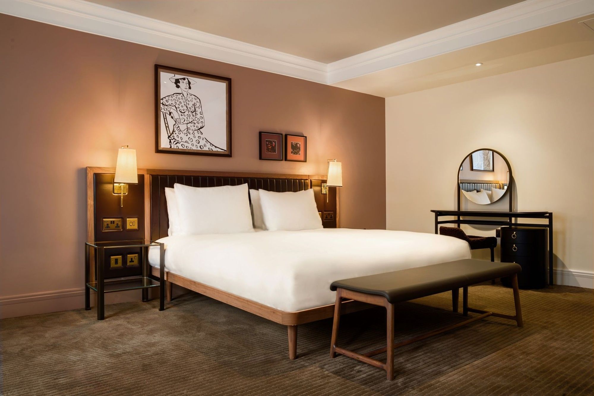 Collection Superior Room with two white pillows, a large king bed, and a bench at The May Fair Hotel, London.