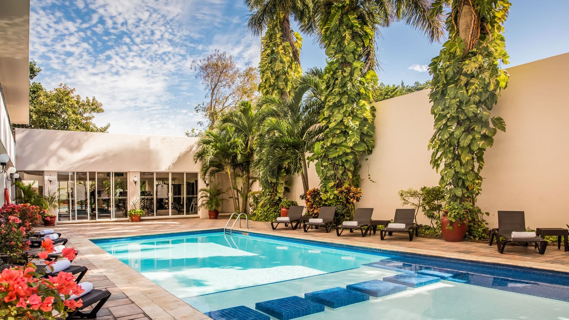 Sunbeds by the pool at Gamma Mérida el Castellano