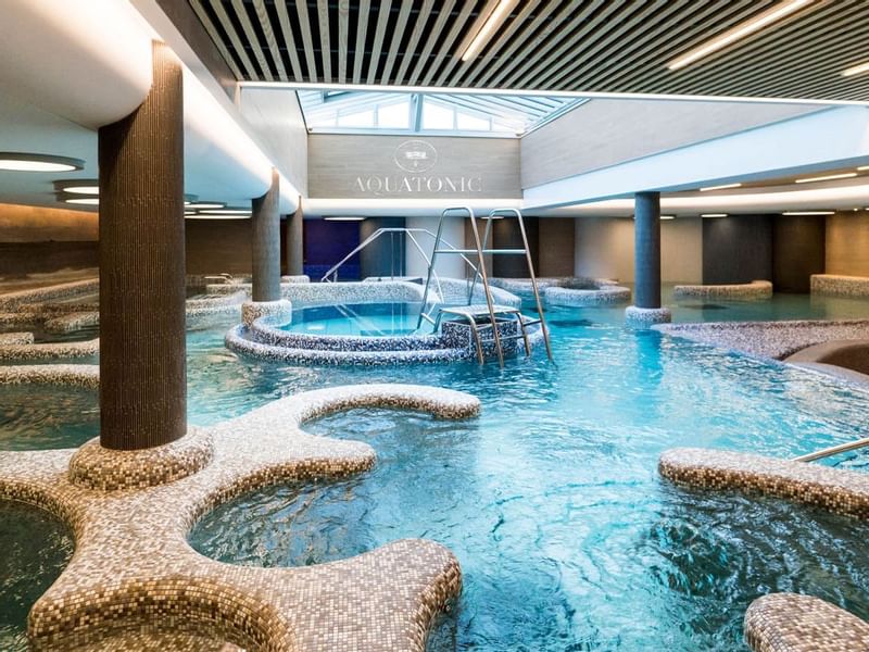 Illuminated indoor pool at Le Grand Hôtel des Thermes