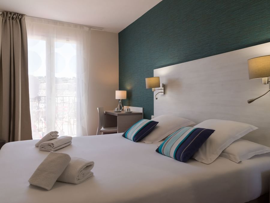 Folded towels on a bed in Superior Double at Originals Hotels