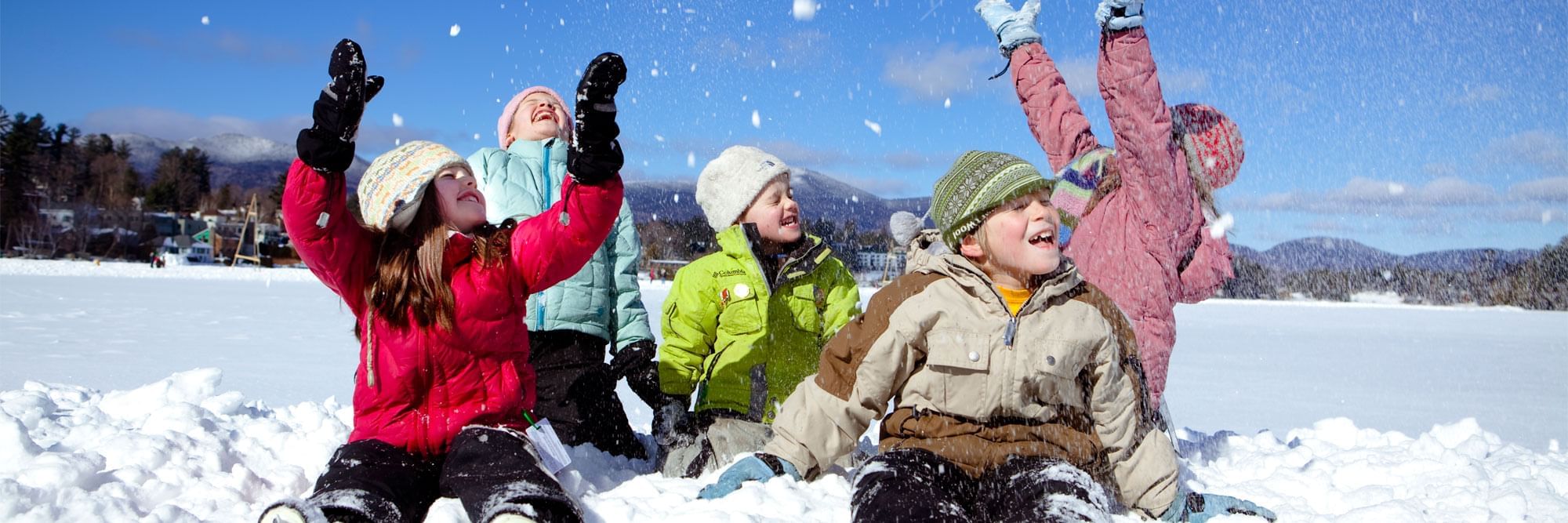 Kids throwing snow in the air.
