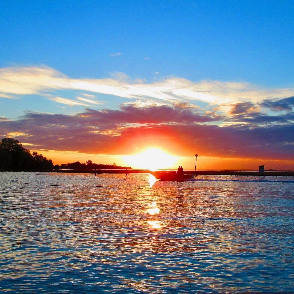 Boat in a lake at sunset near Falkensteiner Hotels