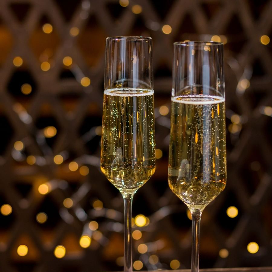 Close-up shot of two champagne glasses served during festive seasons at The May Fair Hotel