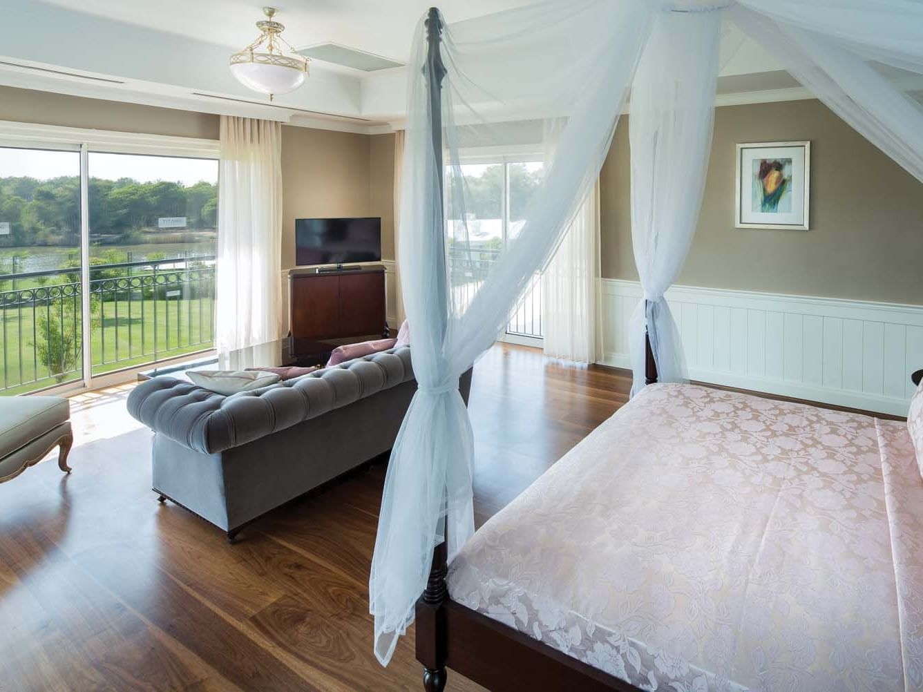 Comfy bed and lounge with an outside view in a room at Titanic Deluxe Golf Belek