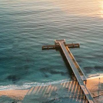 Aerial view of the pier at the beach near Be Fremantle