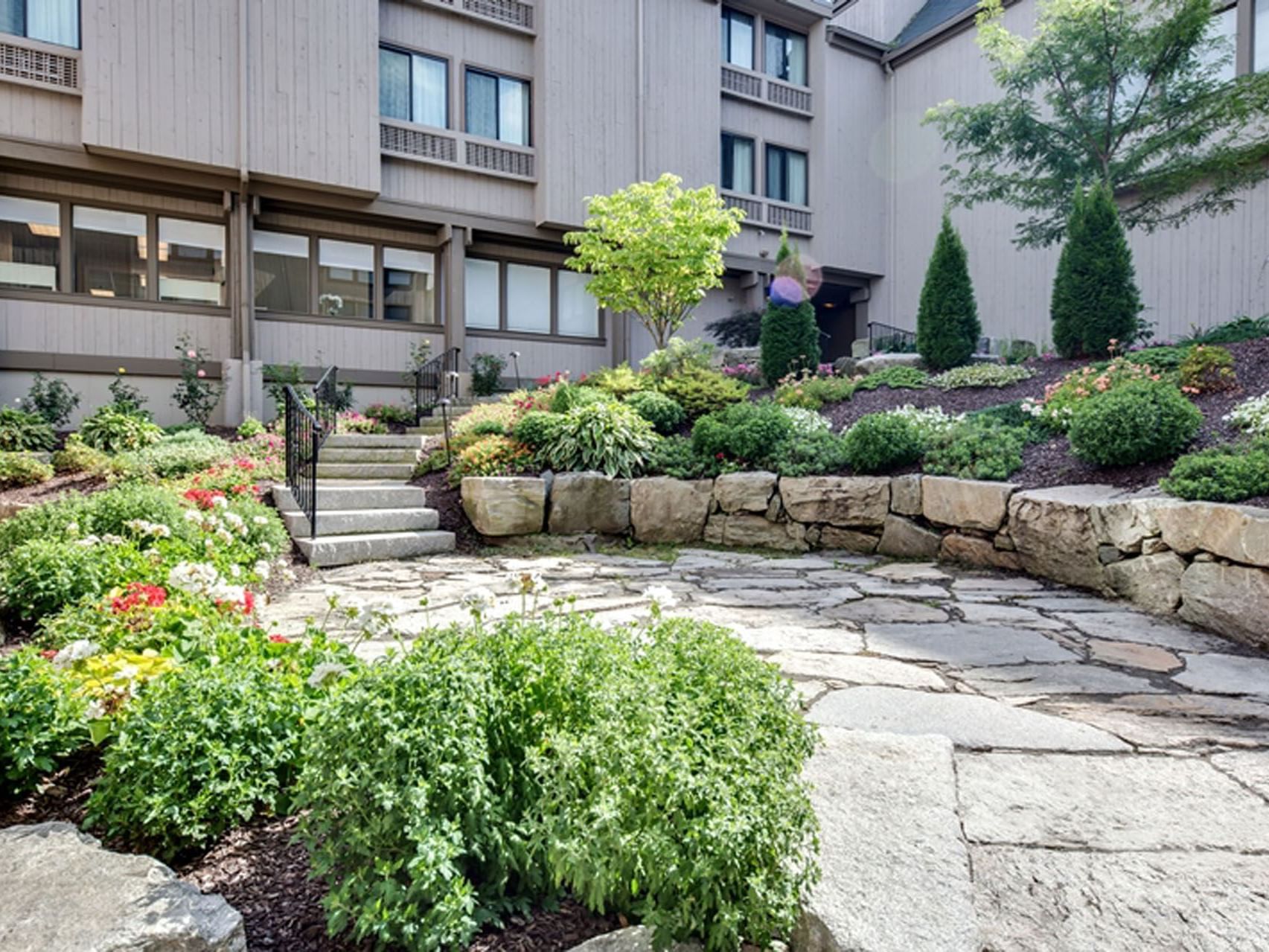 stone courtyard, flowers, trees, fauna, stone paver landing