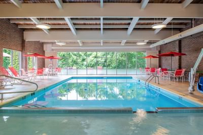Indoor pool area with lounge area at White River Inn and Suites, one of the best hotels in white river Jct Vt