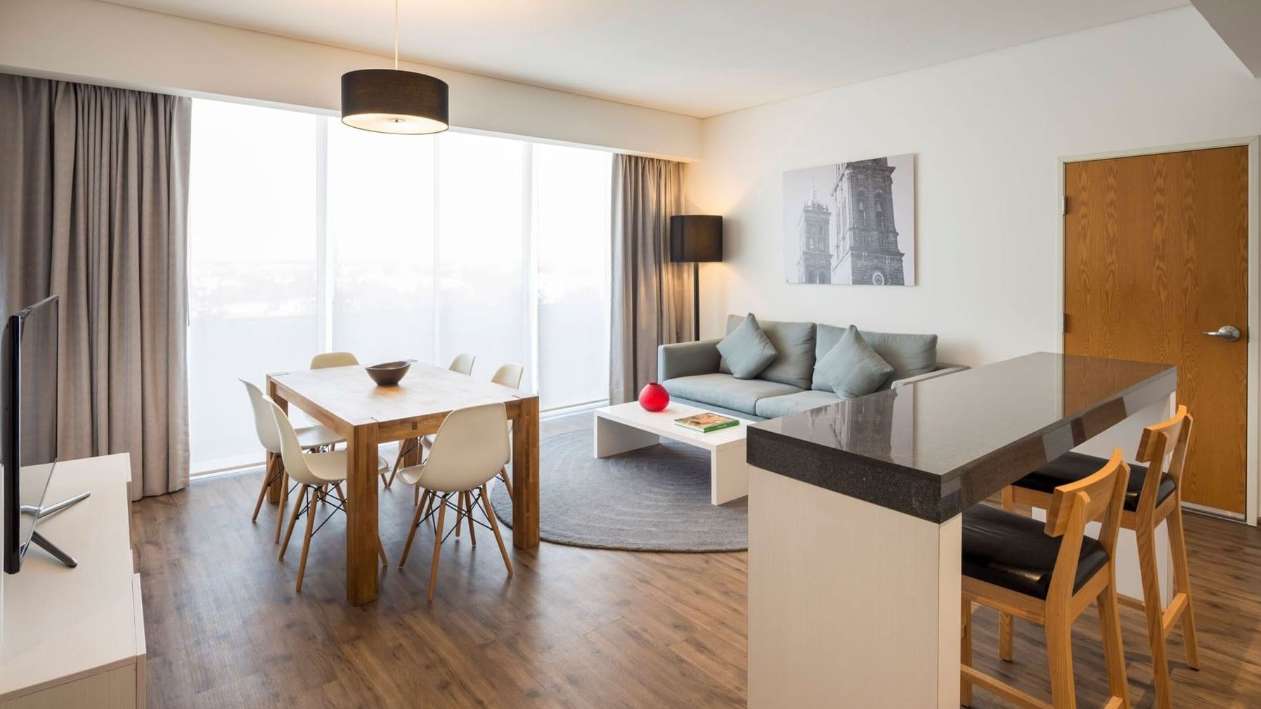 King Suite 1 Room living space with a dining set and a comfortable grey sofa at Camino Real Puebla Angelopolis