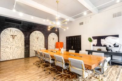Conference room with unique wall art and wooden floors in the Business Center at The Riverwalk Plaza Hotel