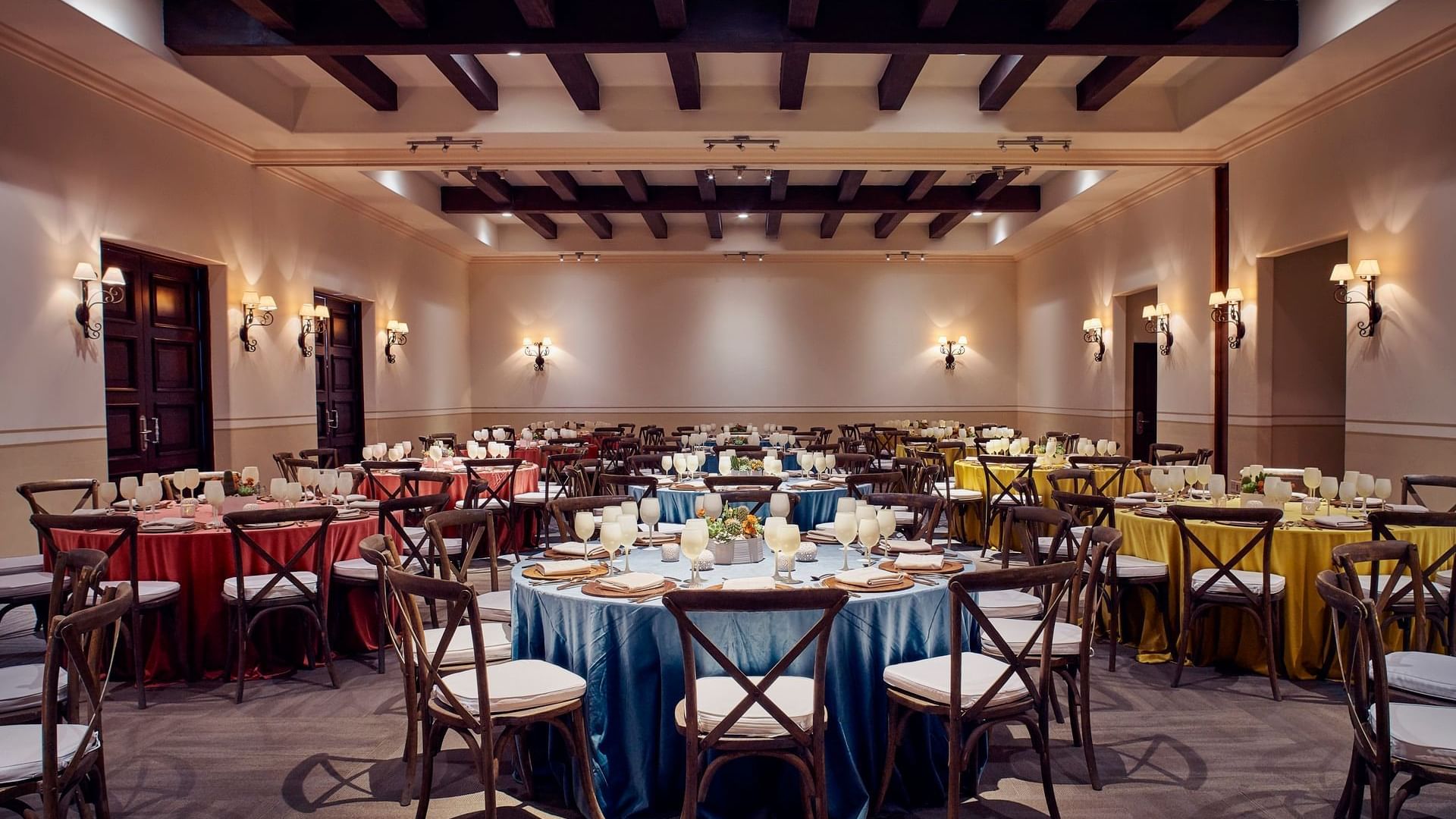 Arcos Room Dinner arrangements with round tables and elegant lighting at Hacienda del Mar Los Cabos