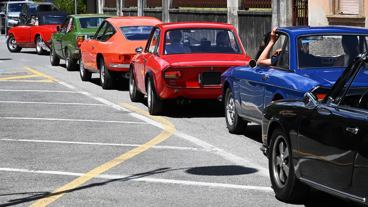 Colorful vintage cars lined up at a car show