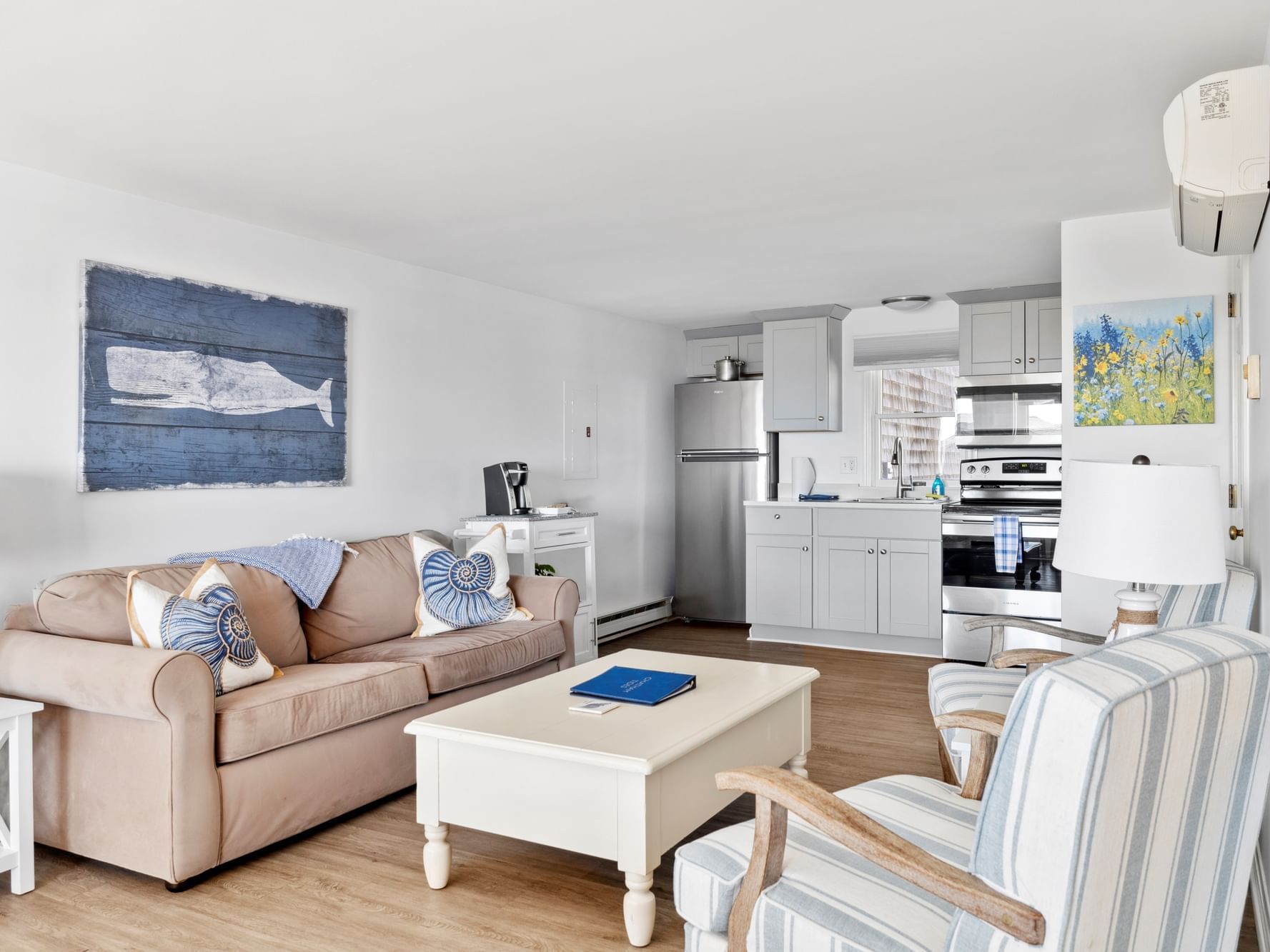 Living area with arranged seating by full kitchen in Unit 20 - Hightide Townhouse One King at Chatham Tides Resort