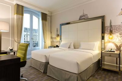 Bed & furniture in Twin Deluxe Room at Hilton Paris Opera Hotel