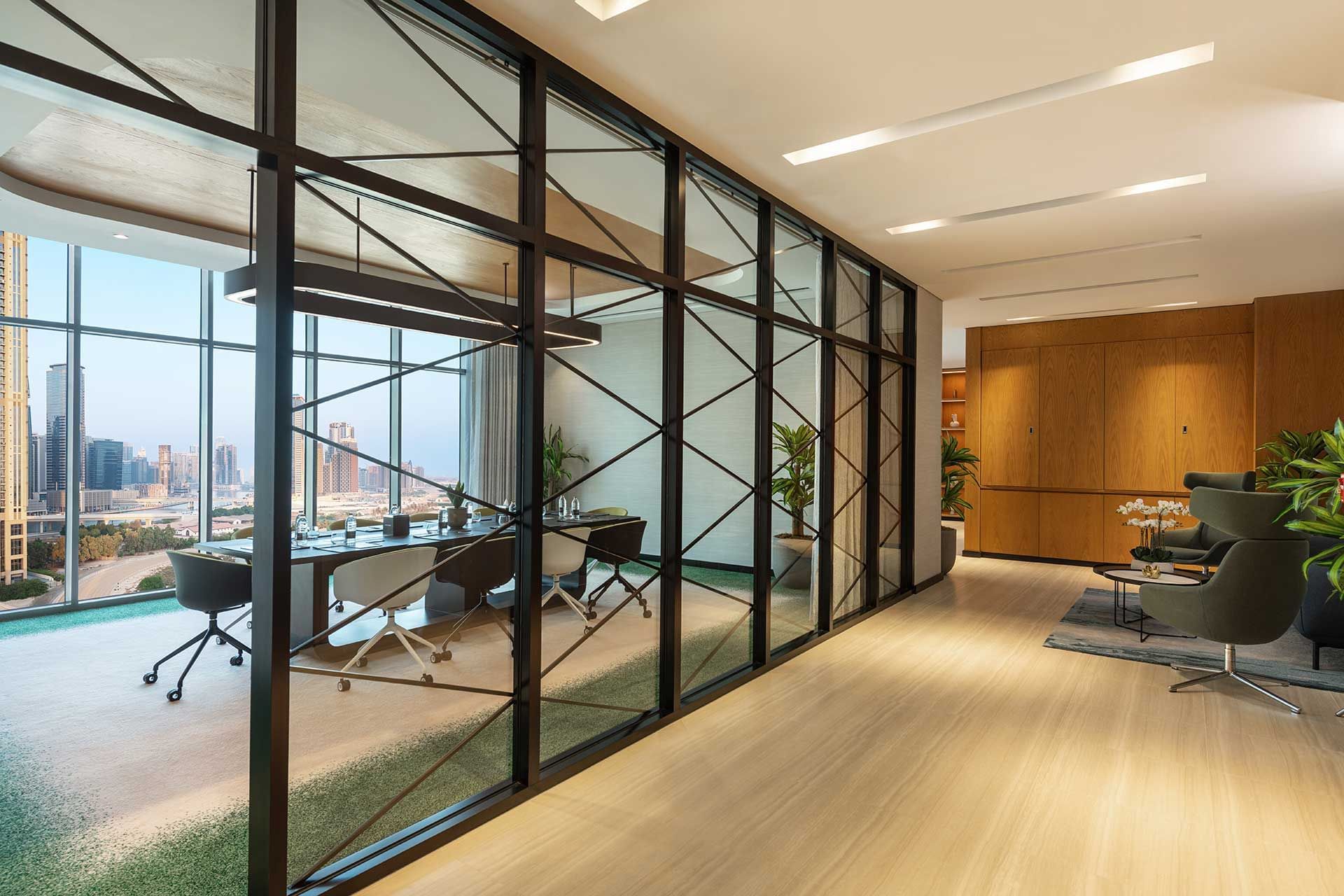 Modern office interior with glass walls overlooking a cityscape at DAMAC Maison Aykon City