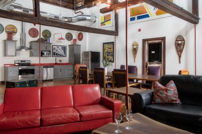 Living area with cozy sofa & dining table in Apartment 404 at Retro Suites Hotel