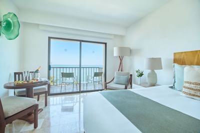 An elegant luxury resort bedroom with double beds, crisp white linens, and warm ambient lighting.