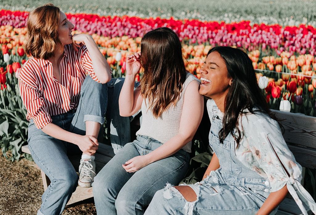 girlfriends at a tulip festival laughing