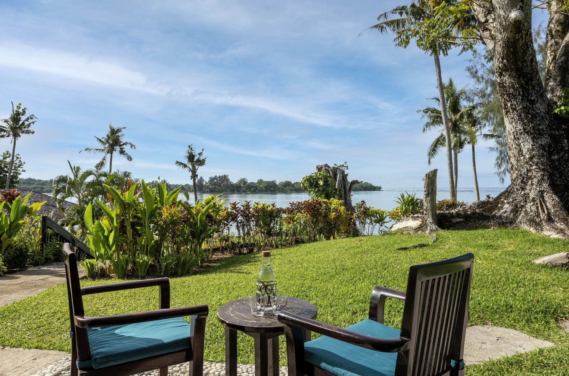 Scenic outdoor seating area on a lush green lawn in Lagoon View Room Terrace at warwick le lagon-vanuatu