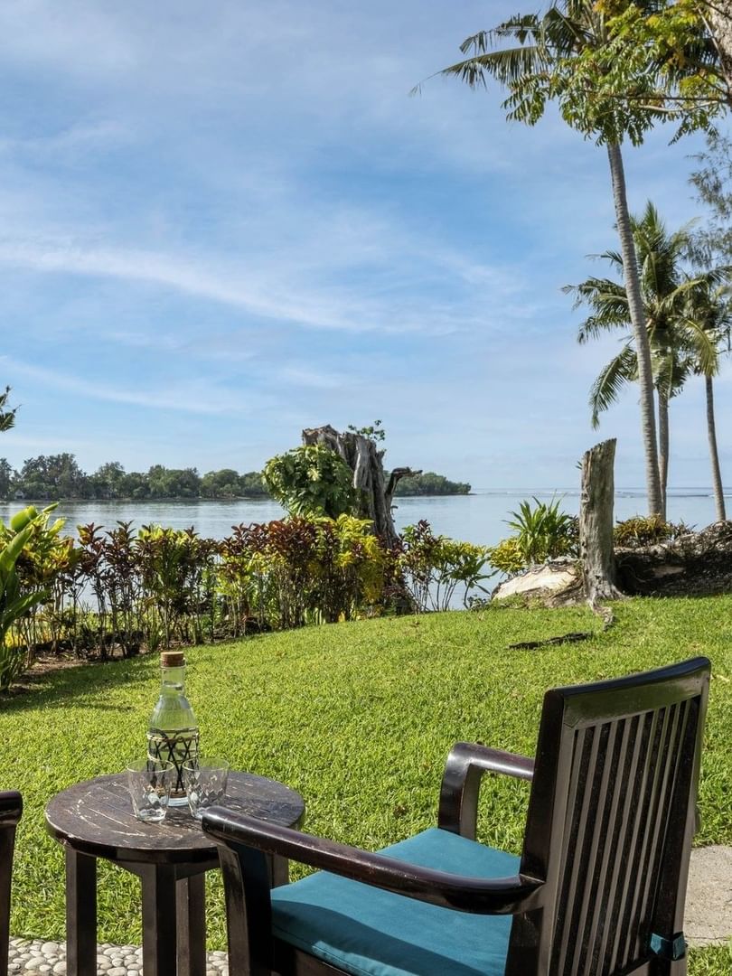 Scenic outdoor seating area on a lush green lawn in Lagoon View Room Terrace at warwick le lagon-vanuatu
