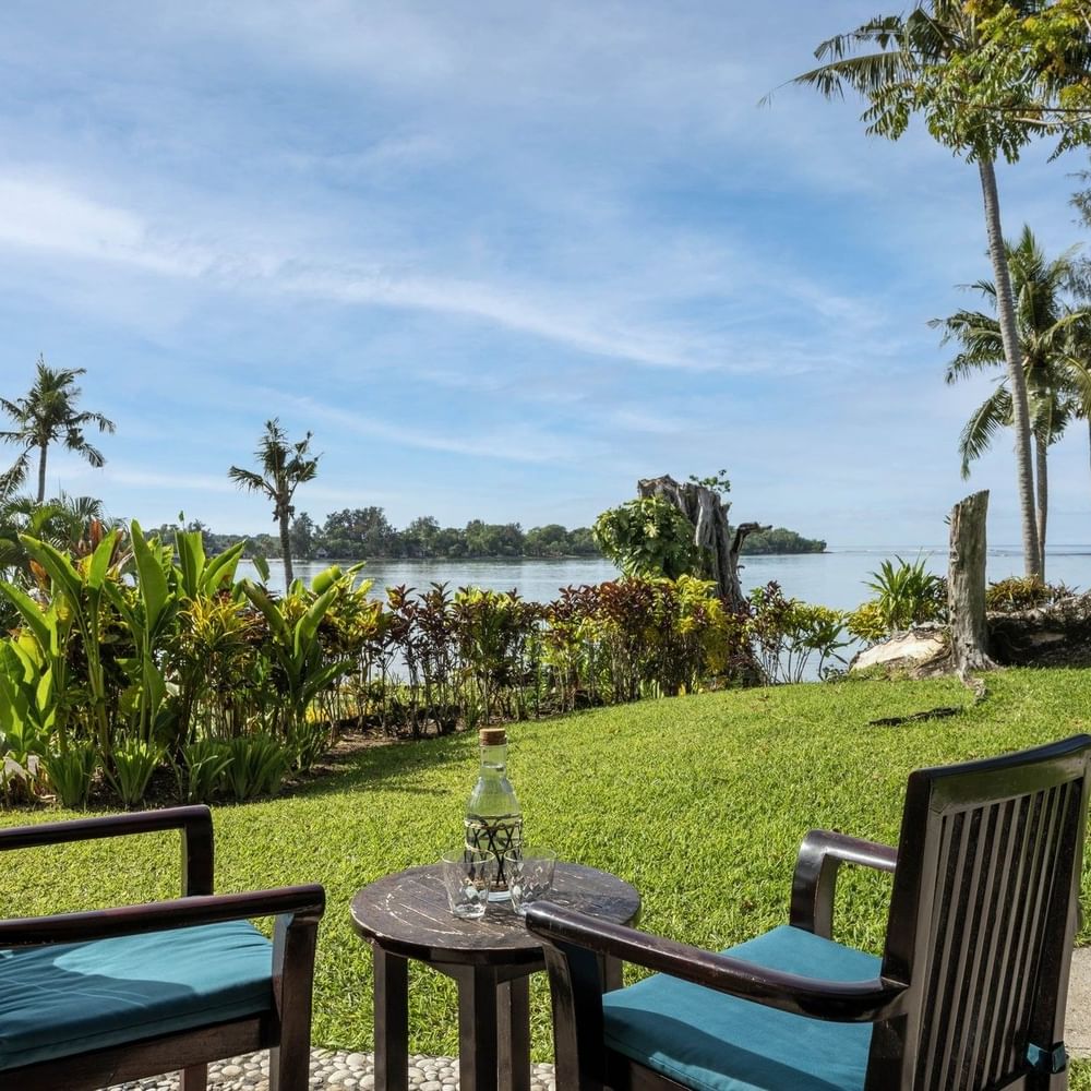 Scenic outdoor seating area on a lush green lawn in Lagoon View Room Terrace at warwick le lagon-vanuatu
