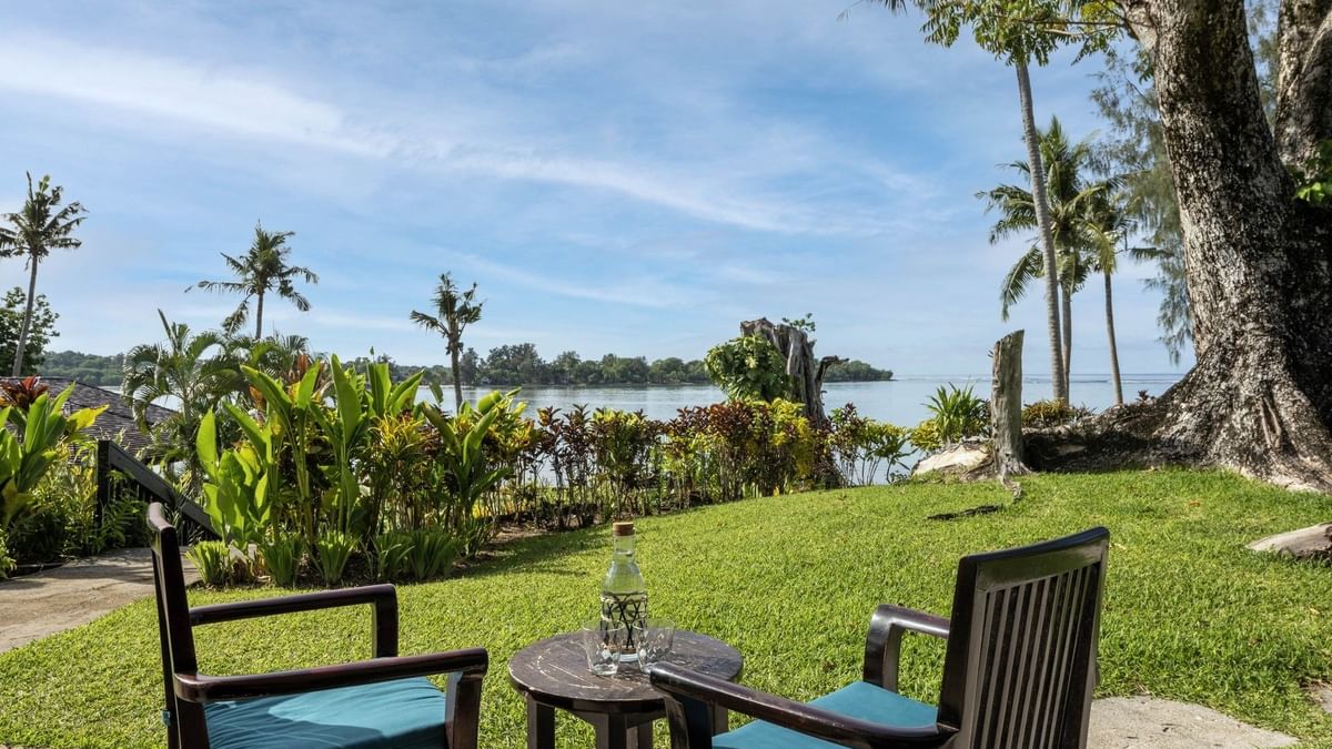 Scenic outdoor seating area on a lush green lawn in Lagoon View Room Terrace at warwick le lagon-vanuatu
