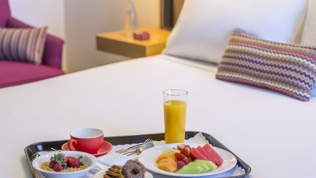 Breakfast tray on the bed in Mercure Privilege Rooms at Pullman and Mercure King George Square Brisbane