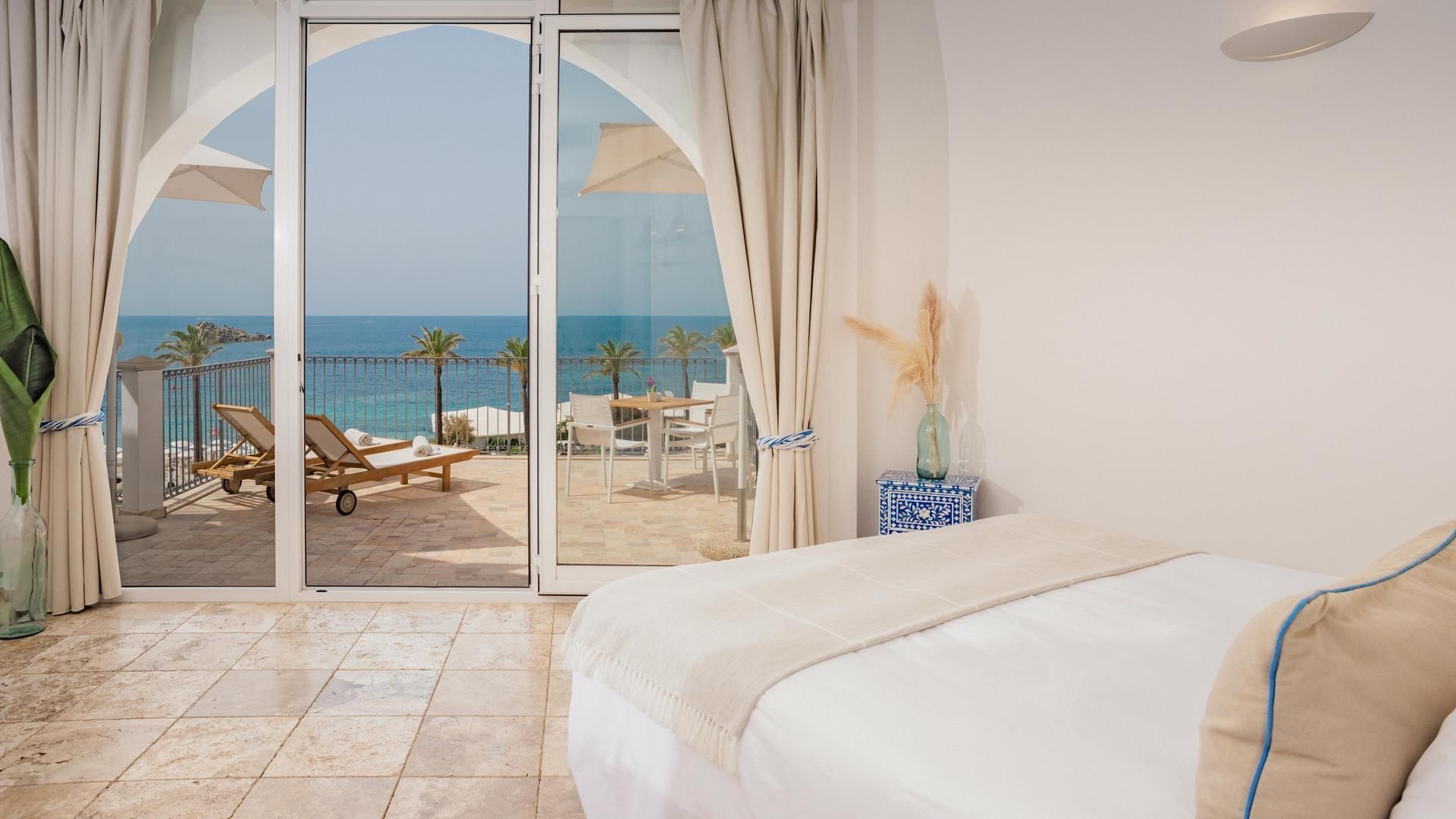 Bedroom & balcony in Capo Boi Suite at Falkensteiner Hotels