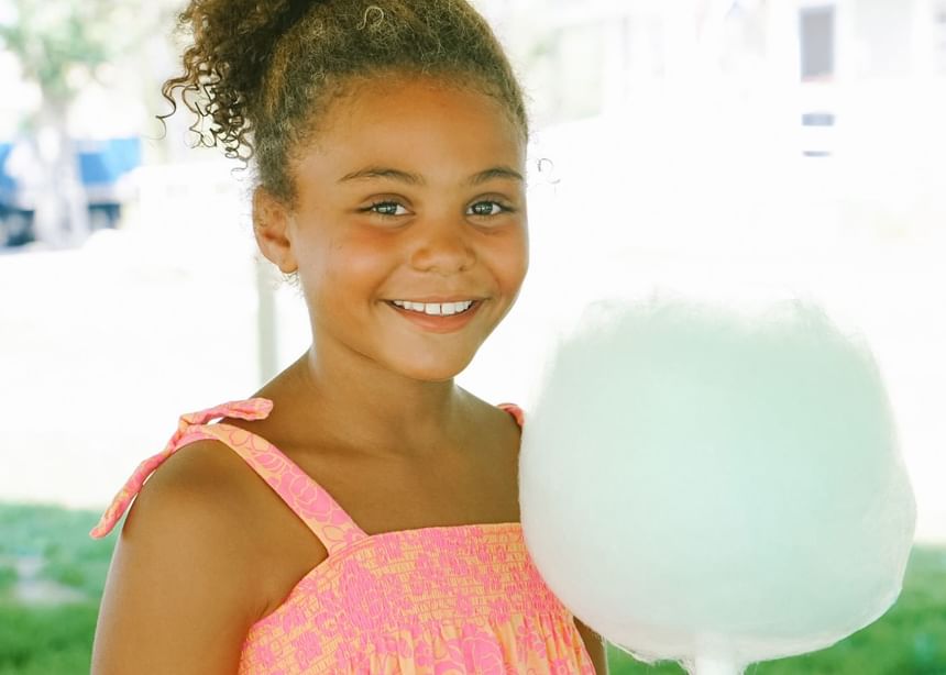 Close-up of a girl posing while holding a cotton candy at Sebasco Harbor Resort