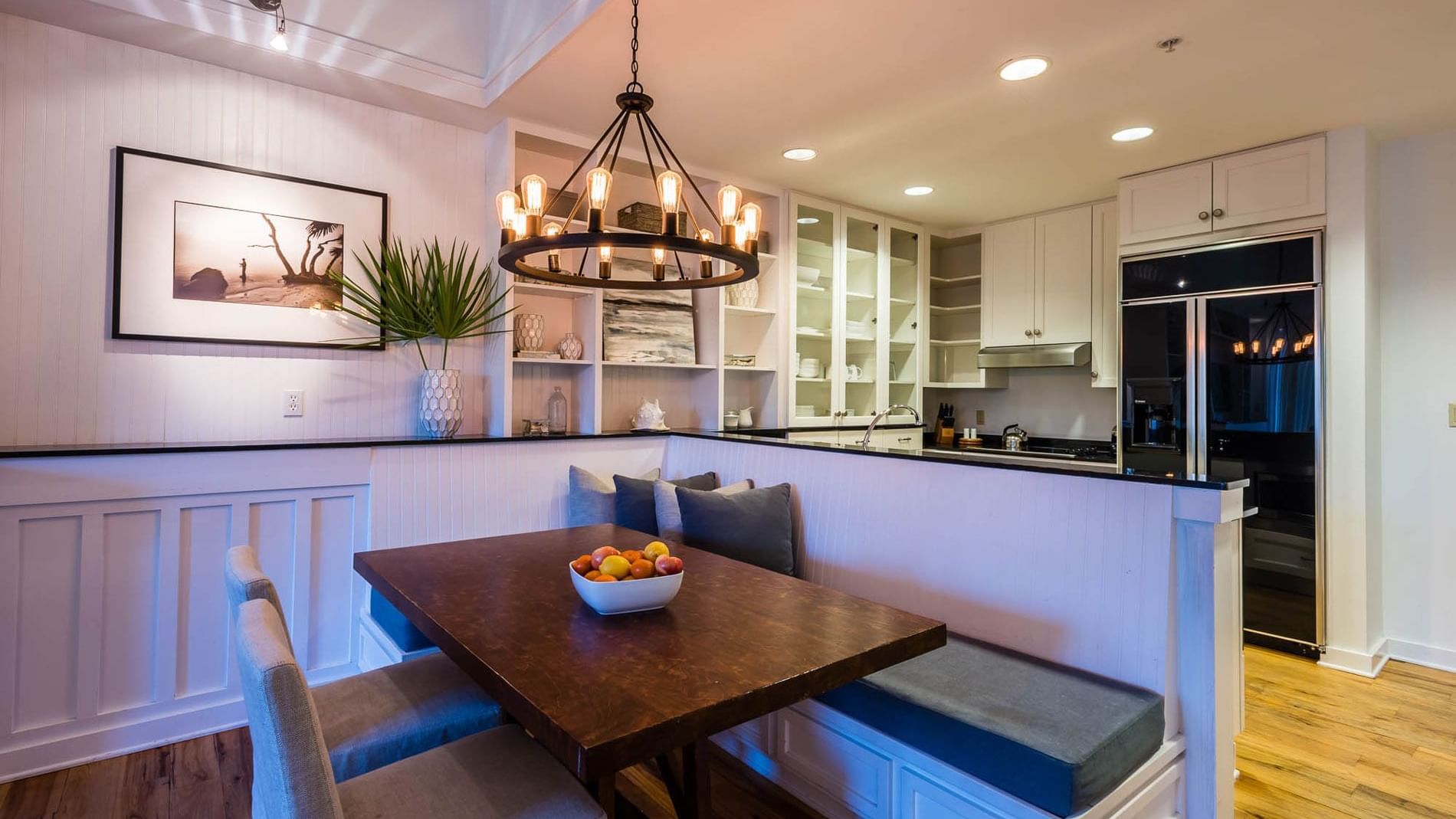 Dining table by the kitchen area in Resort Suite with wooden floors at Watersound Inn