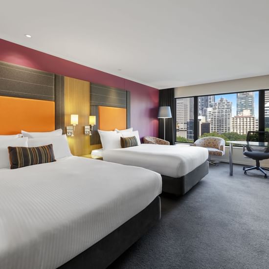 Workspace facing the beds in Superior Twin Room with carpeted floors at Pullman Sydney Hyde Park