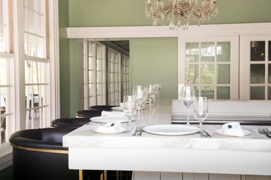 Well-prepared dining table in a room with an elegant chandelier at The Clifton