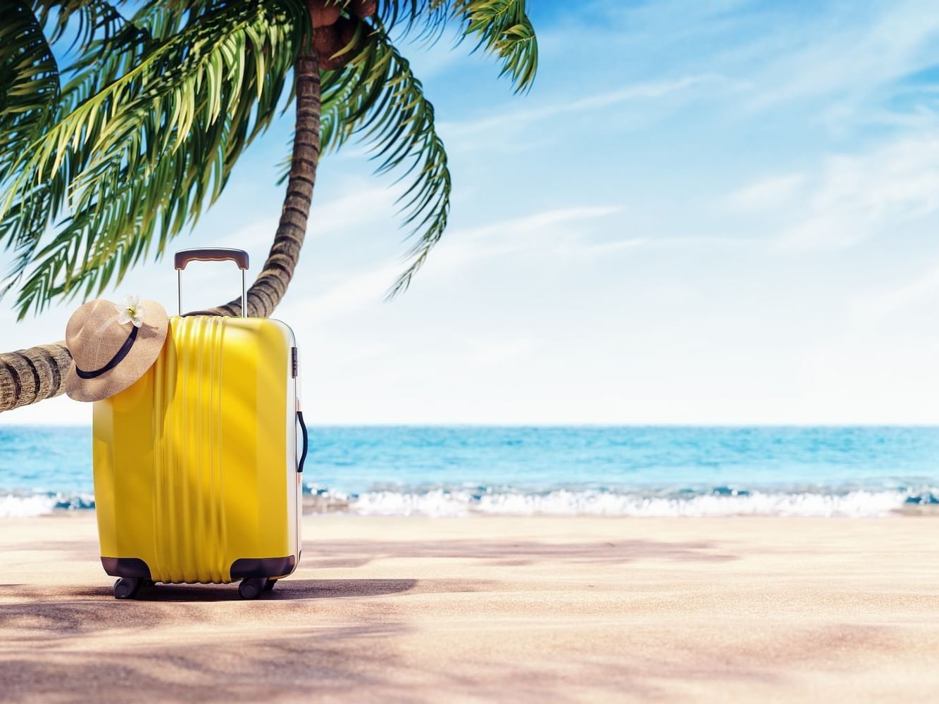 Yellow suitcase under tree on beach at Daydream Island Resort