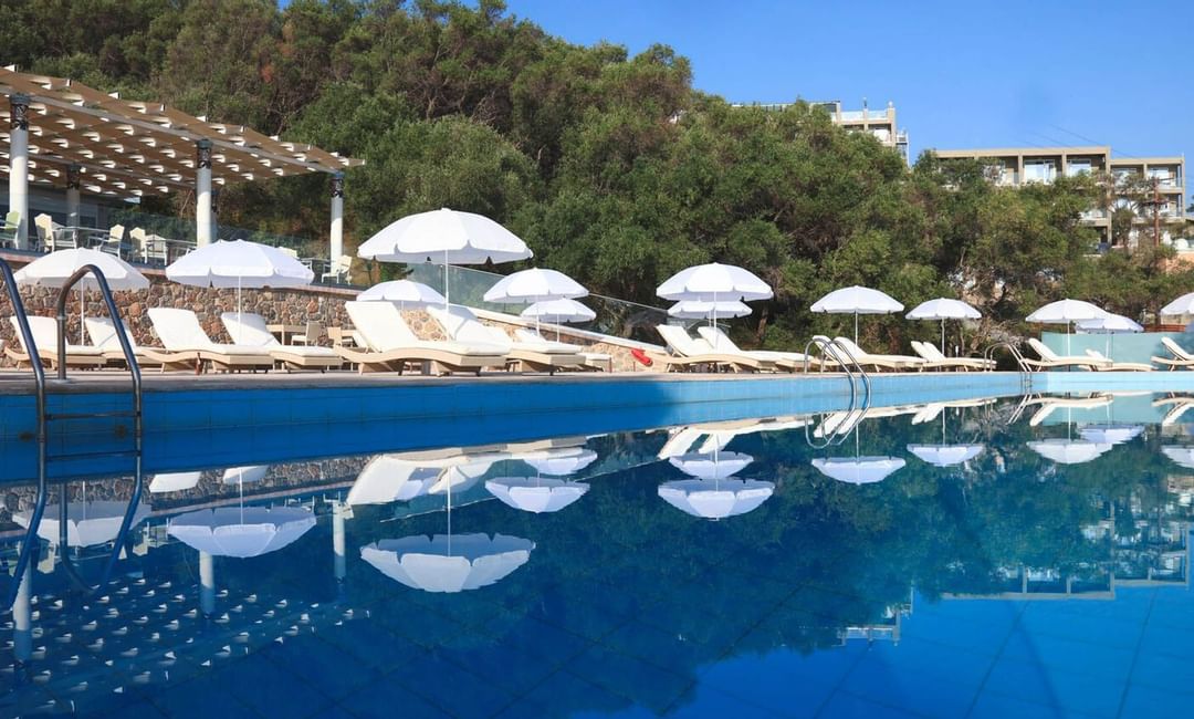Closeup on the pool with pool chairs at Kairaba Hotel